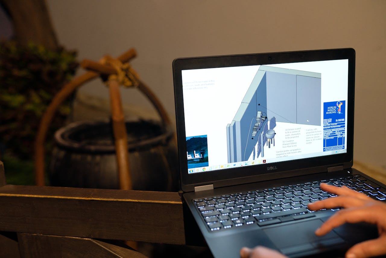 who-we-are Engineer working on a CAD design using a laptop computer. Indoor setting highlighting technology in engineering.
